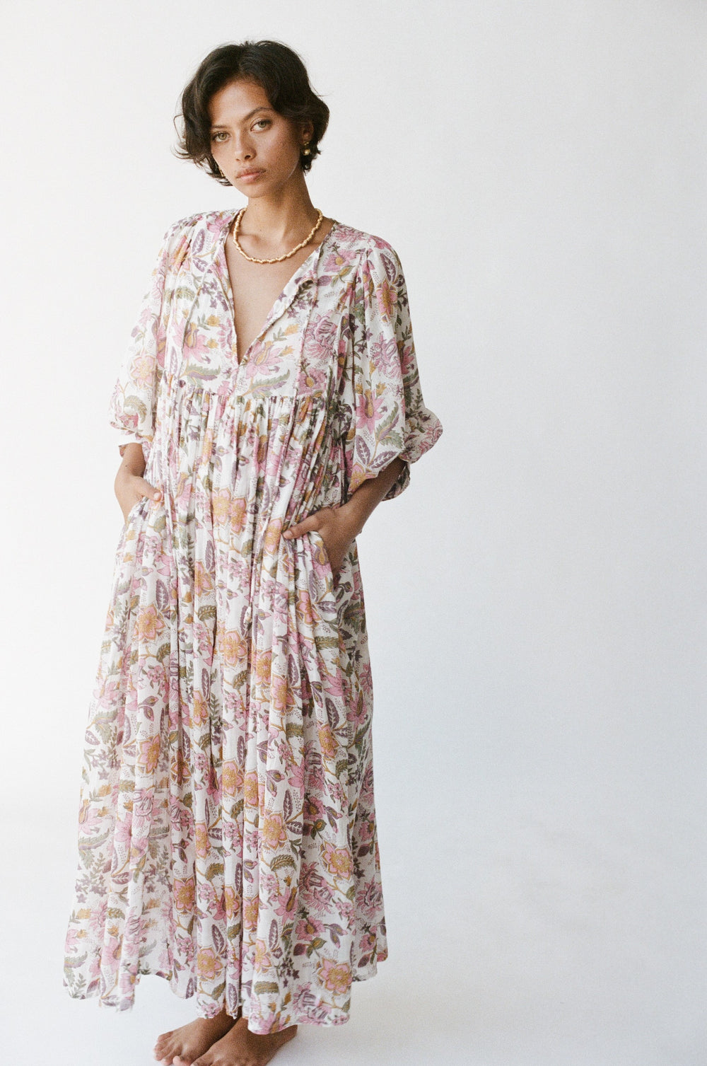 Daughters of India Kyra Maxi Dress in Fuchsia Bloom — studio full length hand in pocket, billowed sleeves, flowing skirt